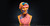 A bust of Andy Warhol in pink, orange and blue camouflage