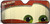 A vehicle windshield sun shade with the brown eyebrows and green eyes of Mater the Tow Truck.