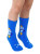 A pair of blew crew socks with rockets on the calves being worn