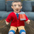 Mister Rogers soft doll displayed on a table and couch in the background. Mister Rogers soft doll displayed on a table and couch in the background.