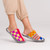 Person wearing colorful knit slippers with a mix of stripes and checker print.