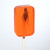 orange, orange flavored lollipop with a cricket encased inside