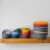 all colors of bowls, stacked on a shelf