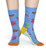 Legs of someone wearing blue socks with multicolor dollar signs. Legs of someone wearing blue socks with multicolor dollar signs.