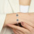 A twister cuff braclet featuring two meteorites set in sterling silver on a woman's wrist