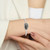 A cuff braclet featuring a meteorite set in sterling silver on a woman's wrist
