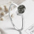 A stackable ring featuring a meteorite set in sterling silver in front of white flowers