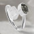 A bypass ring featuring a meteorite and herkimer set in sterling silver on a white cloth