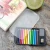 the mini pencil case displayed next to a sketchbook.