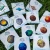 An assortment of enamel pins featuring illustrations of the Sun, eight planets, Pluto, and a comet