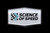 An acrylic magnet with the Science of Speed logo in white
