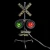 A lit red and green railroad crossing lamp
