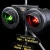 Detail image of a lit red and green railroad crossing lamp