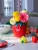 lifestyle photo of the vase placed on a table with flowers.