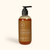 An image of the product. The bottle has a pump handle, and is rounded near the top and bottom. The facial wash inside is a warm amber color.