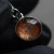 A pendant with martian meteor dust contained in glass against a red background