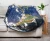 A circular blanket with a photo of the Western Hemisphere used as a decorative throw on a couch