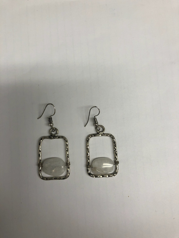 This image shows a square frame earring with a white stone towards bottom of frame.