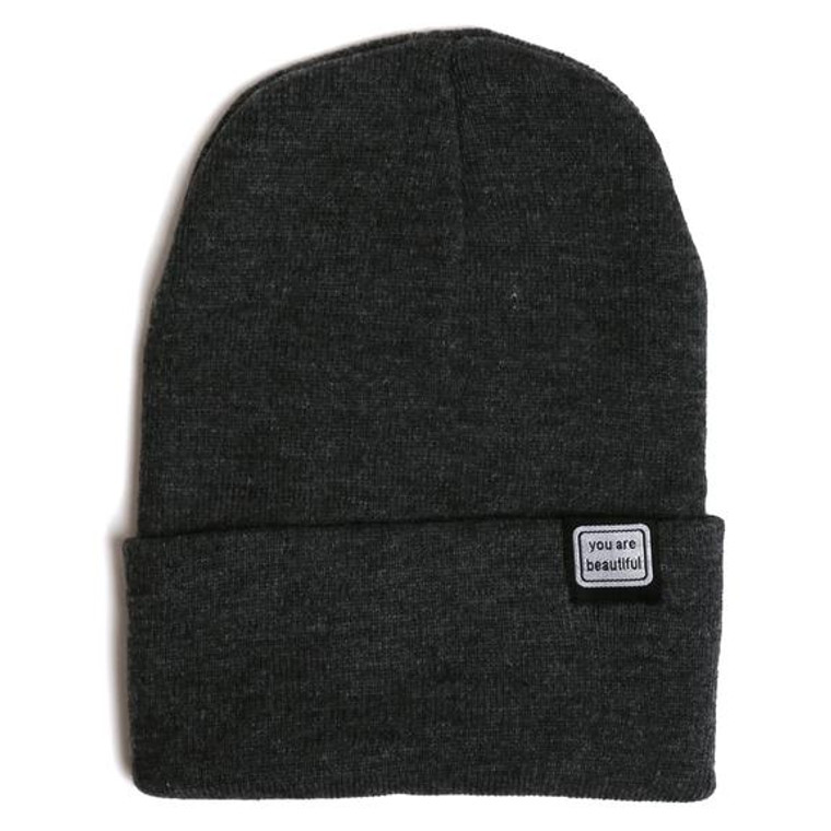 a charcoal beanie with fold over with a small embroidered patch that says "you are beautiful"