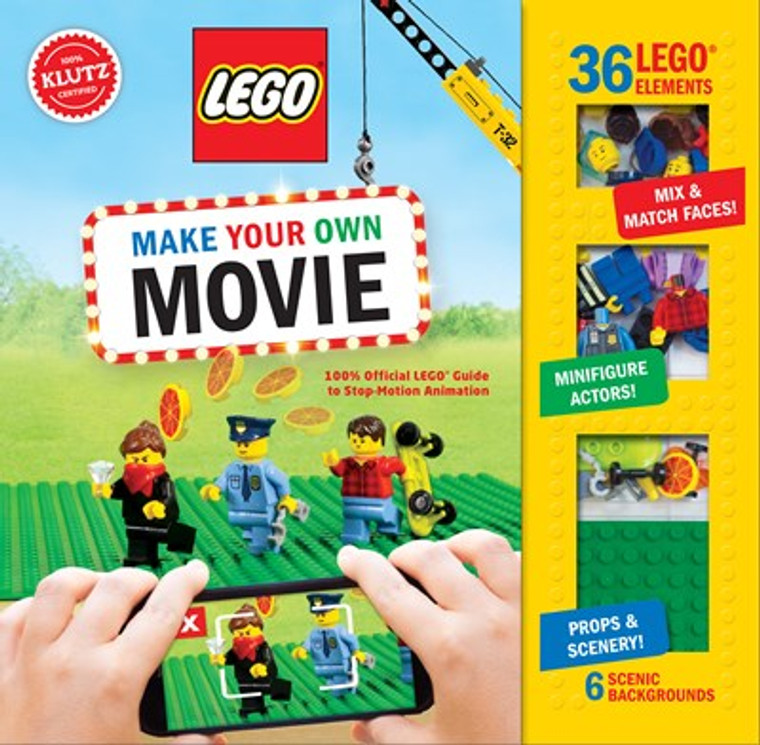 This image shows a book with some Lego figures being filmed with a phone.  Along the side is a clear panel showing some Lego figures.