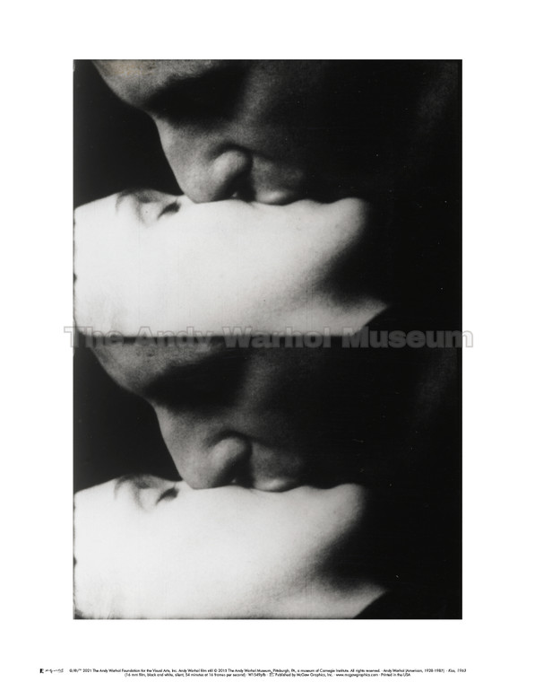 A black and white film still of a couple kissing