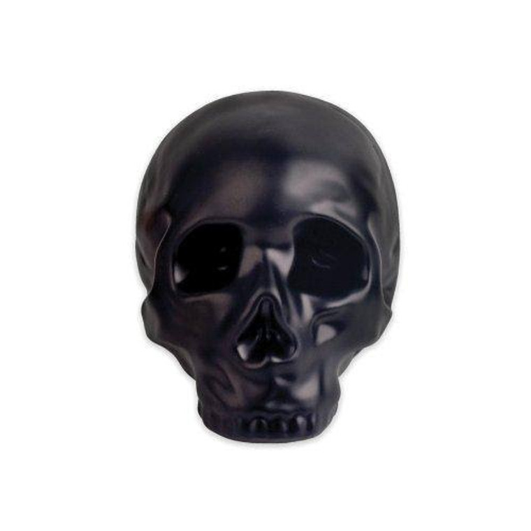 This image shows a black skull coin bank made of stoneware.