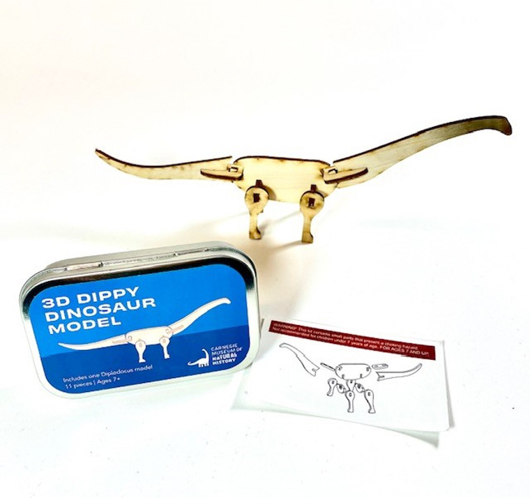 Mini 3D wooden dinosaur with tin case and instructions.