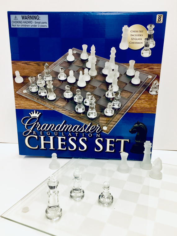 This image is a blue and brown colored box with a picture of a clear and frosted chess set on it.  There is a picture of a Black Knight on it also.  Across the bottom is Written Grandmaster Regulation Chess Set.