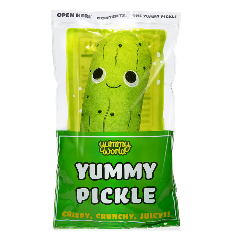 A plush green pickle in a bag