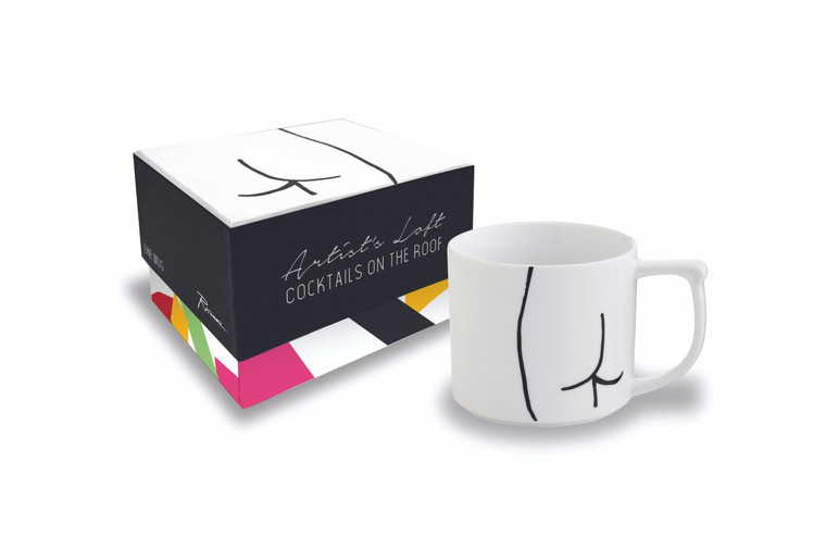 A white mug with buttocks drawing in front of a matching gift box