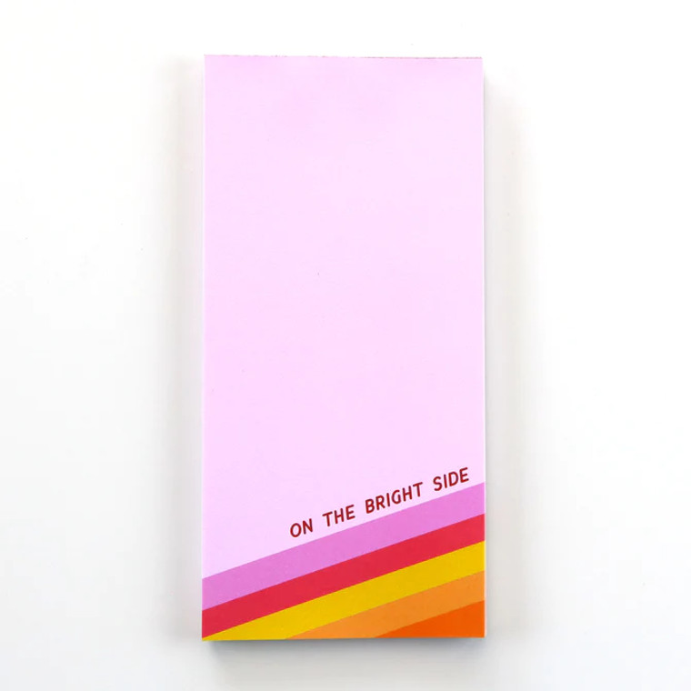 A pink rectangular notepad, with bold red text: on the bright side