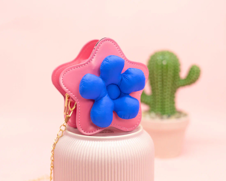 Pink and blue star shaped bag on a pedestal.