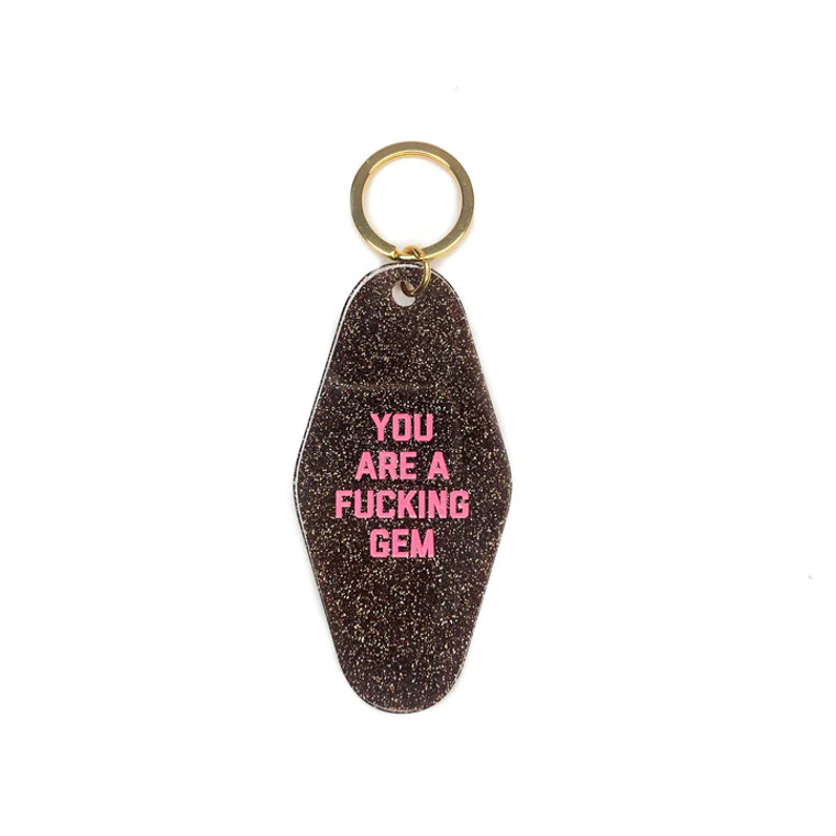 Gold keyring on a glitter keychain with pink embossed text, "you are a fucking gem".
