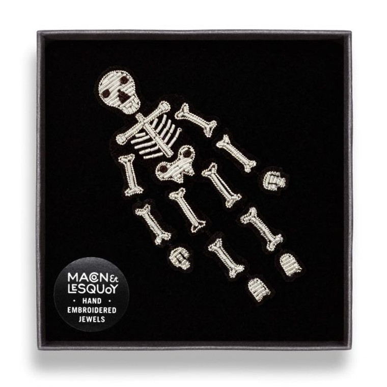 The skeleton brooch placed in it's black gift box.