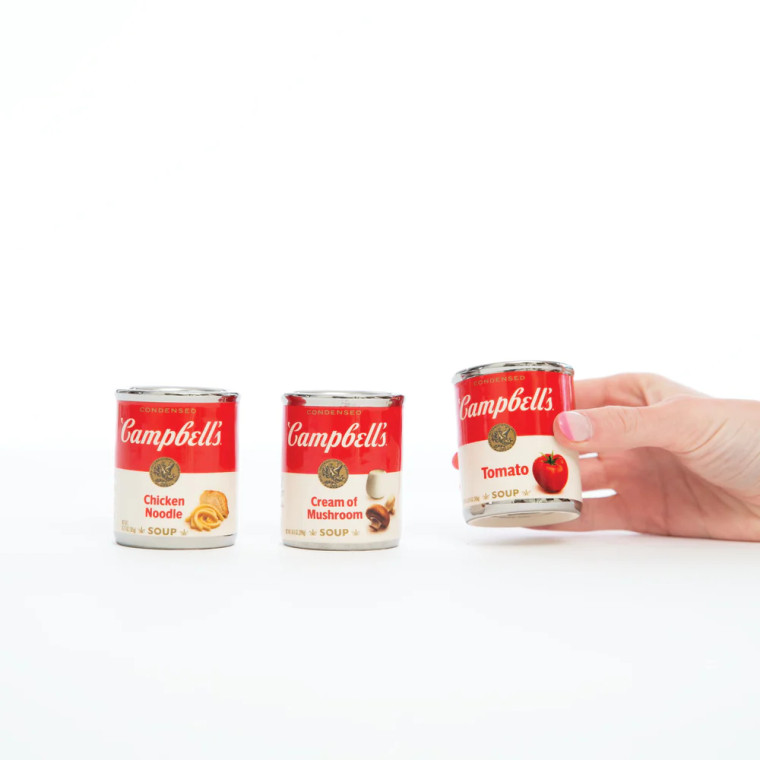 Three campbell soup can shot glasses, a hand holding one