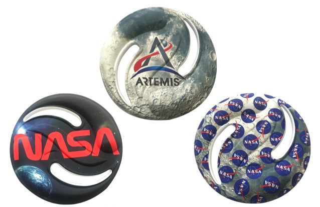 Three foam flying disks with thw logos for the Artemis program, the NASA worm, and the NASA meatball