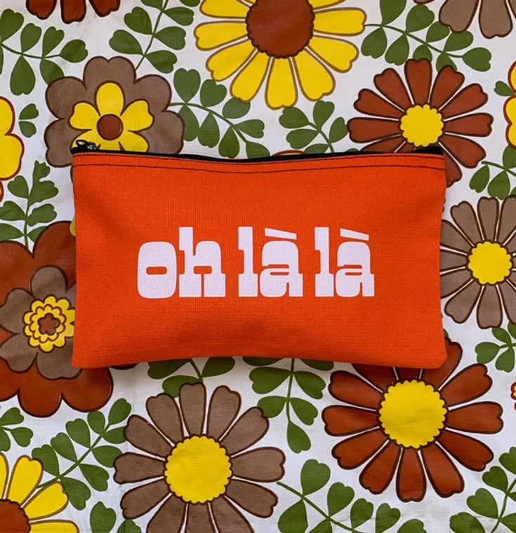 Bright orange pouch with white letters. Text, oh la la