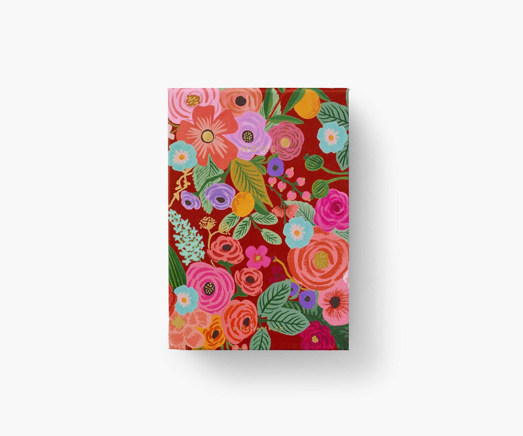 Brick-colored notepad with vibrant floral design.