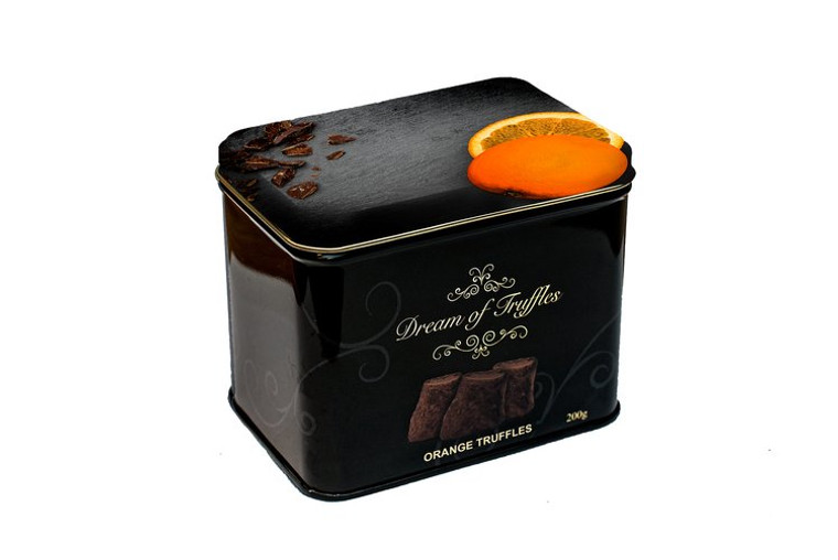 tin box for truffles, says "dream of truffles" in gold script on the front. has image of orange on right side of lid