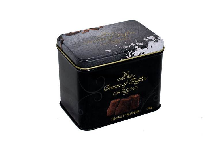 black tin box for truffles. says "dream of truffles" on the front in gold script. image of salt is on the lid