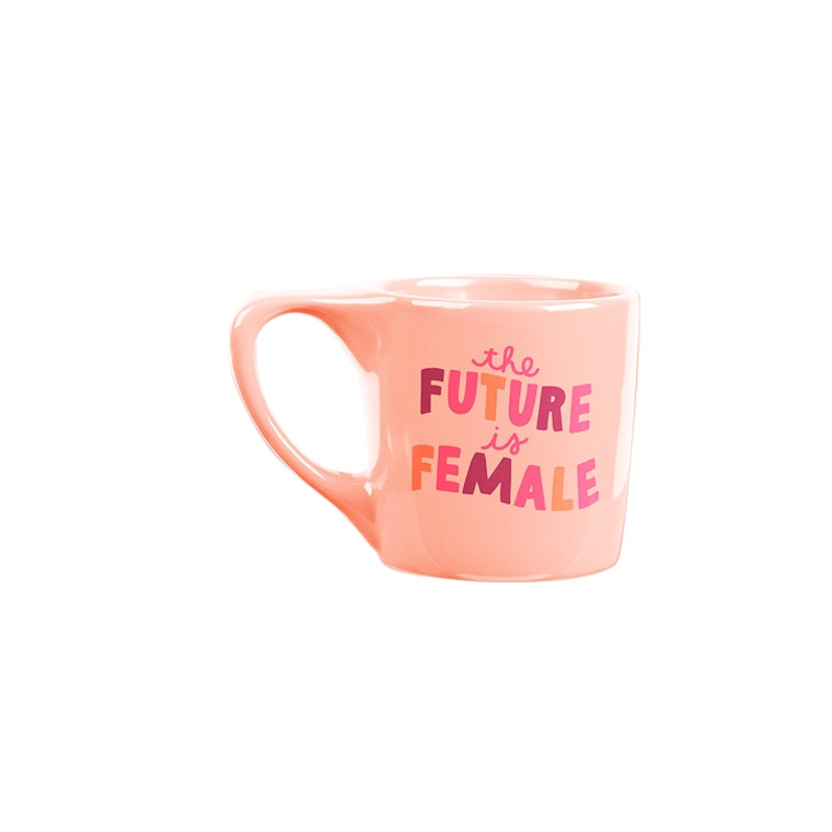 Peach colored mug with orange and pink colored writing.