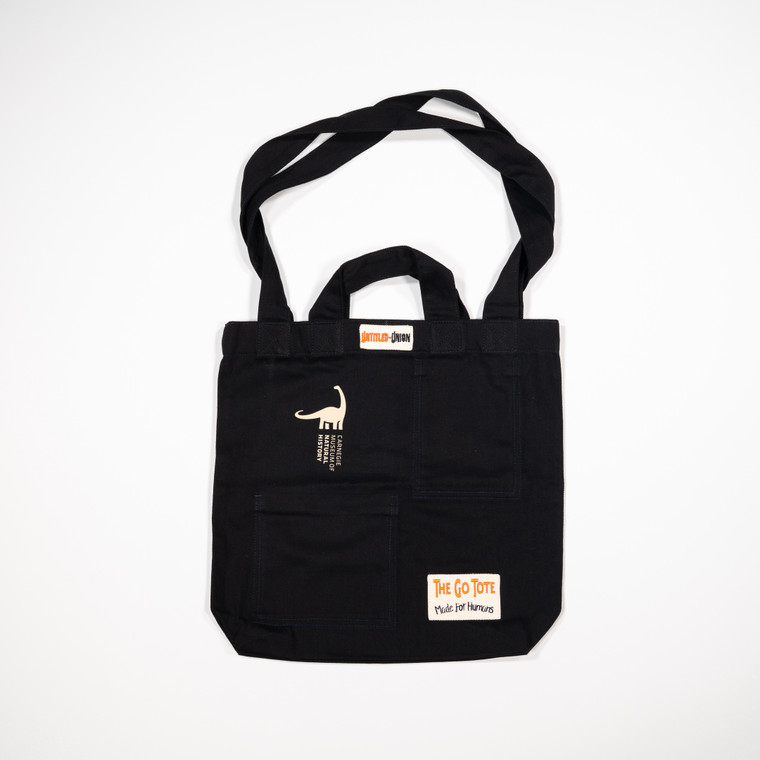 tote laid flat with both sizes of handles out and the CMNH logo printed in the upper left corner in white