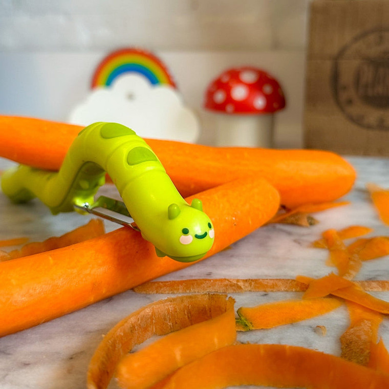 caterpeeler sitting on top of carrots