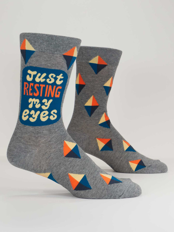 A pair of grey socks, text: Just resting my eyes