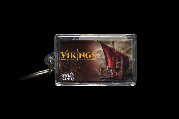 An acrylic keychain with a photo of Viking reenactors on a longship replica and the logo for the "Vikings: Warriors of the North Sea" exhibit