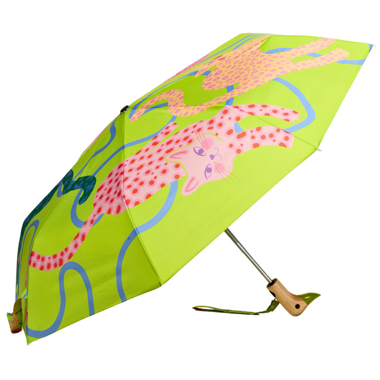 Lime colored open umbrella with bright pattern of cats , side view
