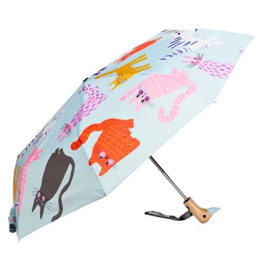 Ice blue colored open umbrella with bright pattern of cats , side view