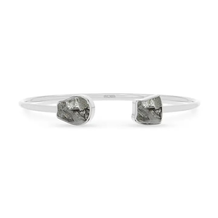 A twister cuff braclet featuring two meteorites set in sterling silver
