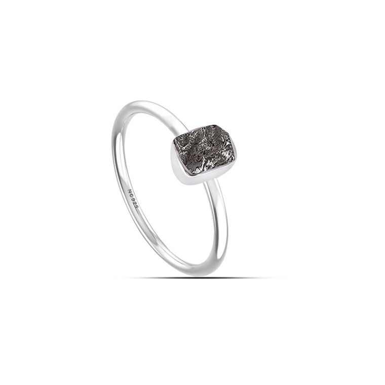 A stackable ring featuring a meteorite set in sterling silver