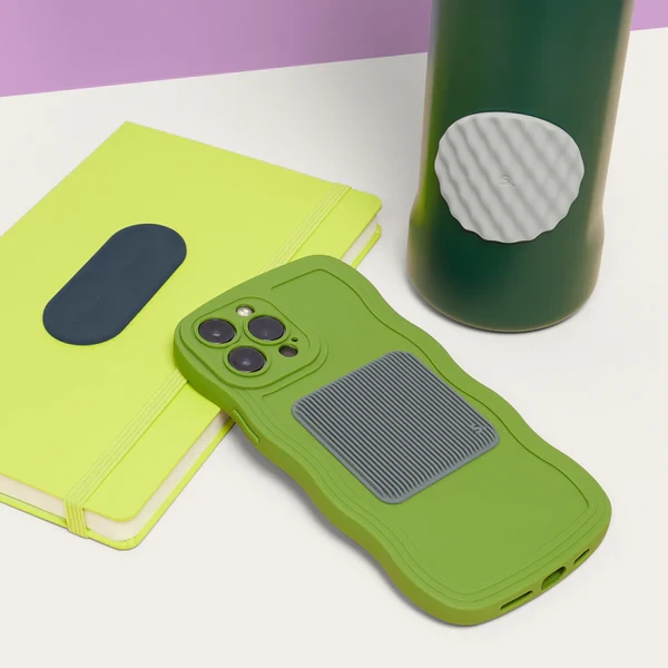 Image shows three examples of the sensory slabs; one is a circle on a water bottle, another a square on the back of a cell phone, and a tab shaped sensory slab on the back of a tablet.